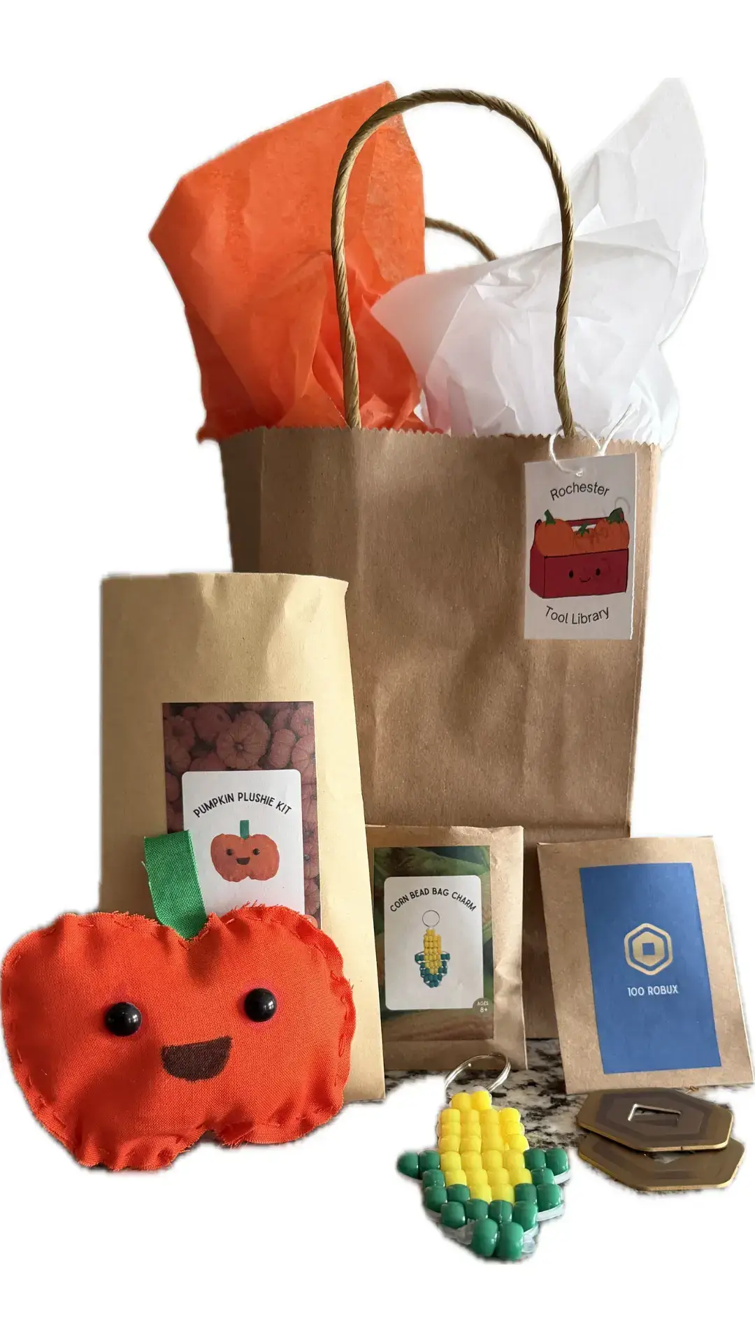 fall goody bag image showcasing pumpkin plushie, corn charm and robux